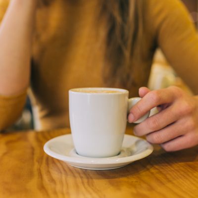 Woman hand holding a coffee mug