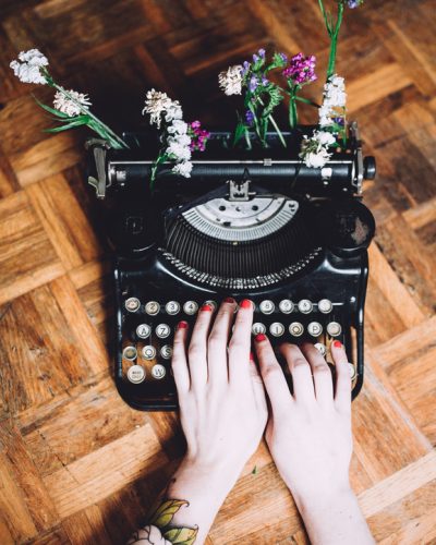Man typing with a vintage typewriter